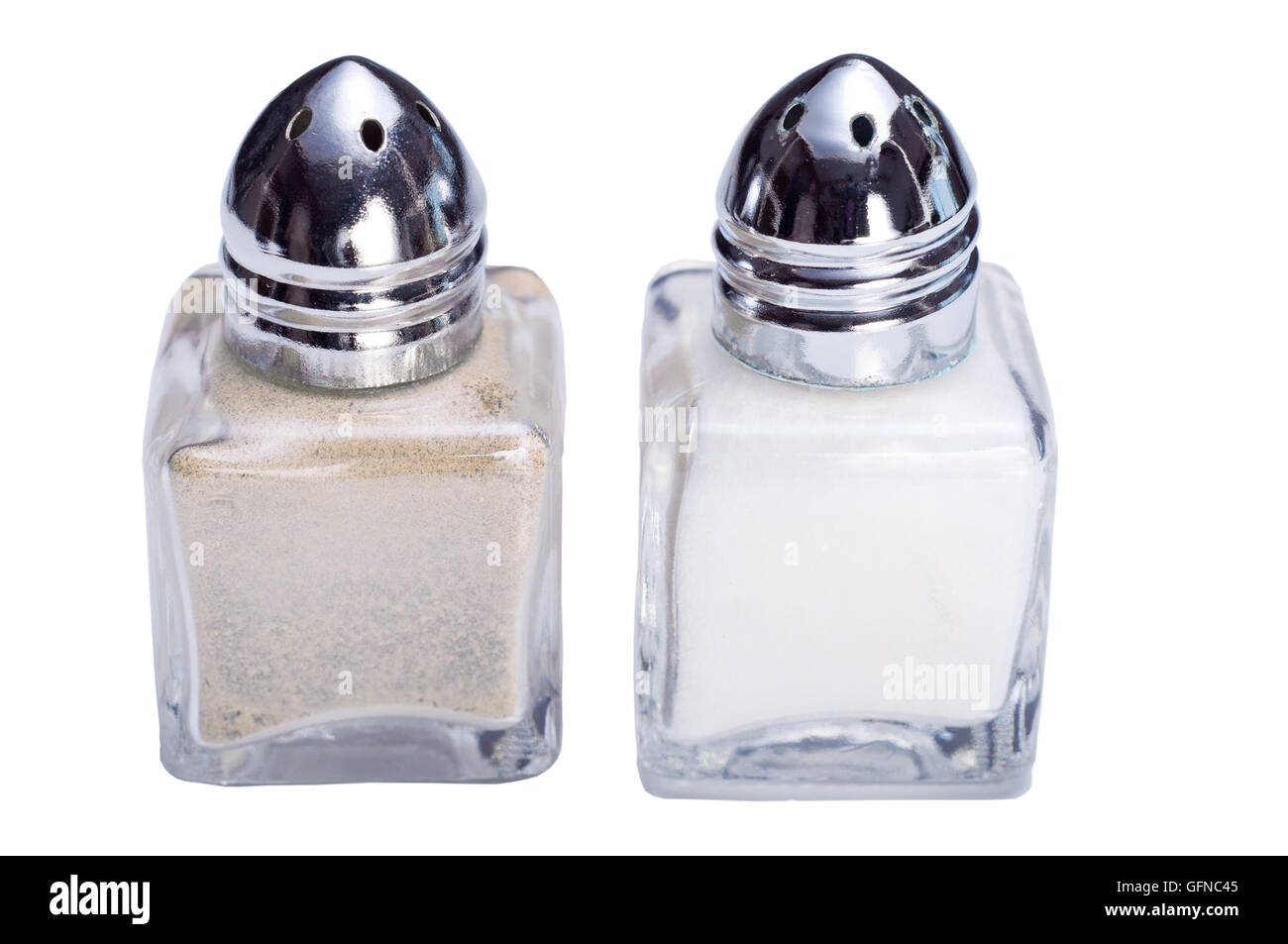 Closeup photograph of small silver and glass salt and pepper cellars Stock Photo