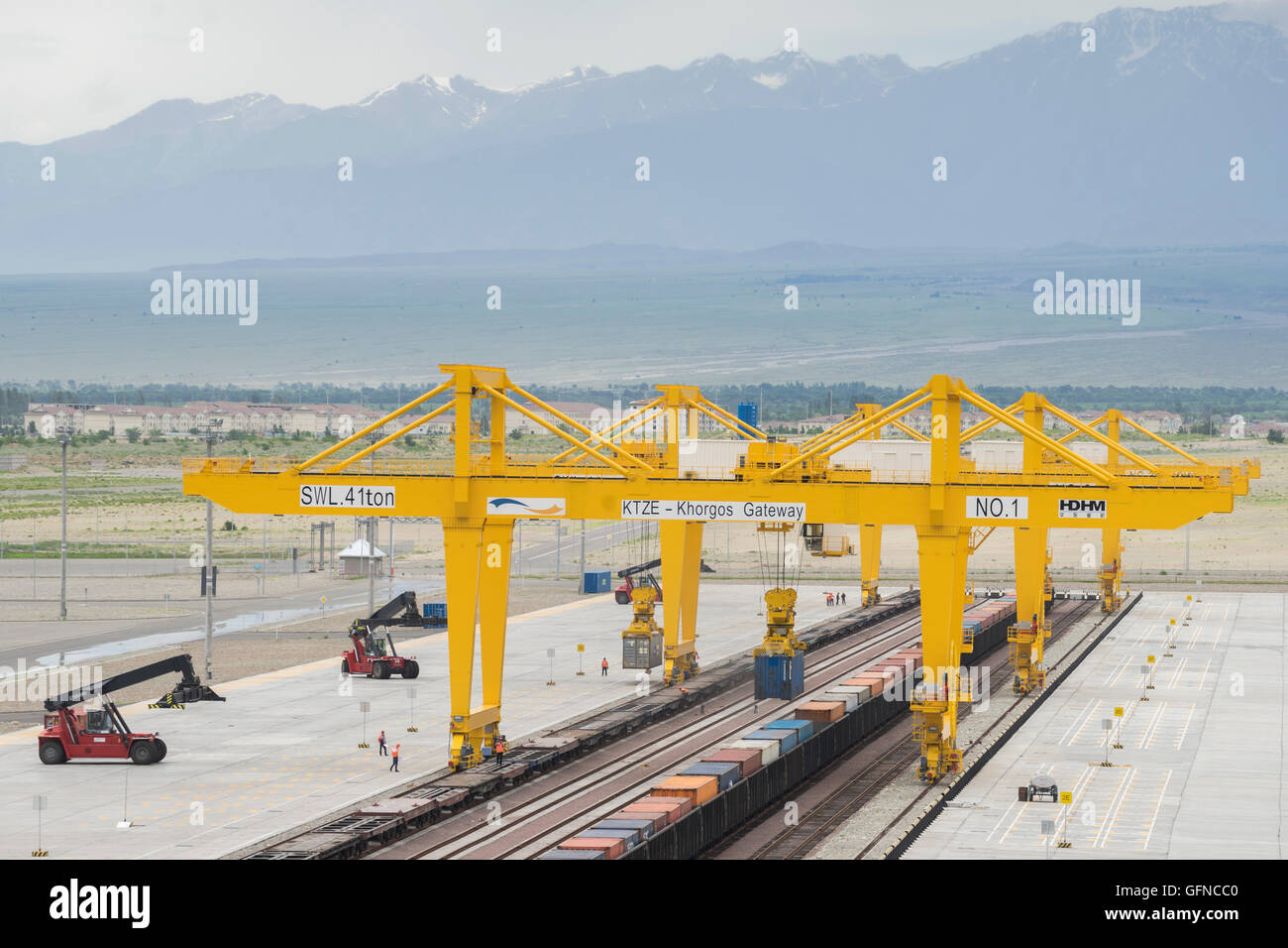 Trains with different gauges from China and Kazakhstan have loads transferred at a dry port in Khorgos, Kazakhstan. Stock Photo