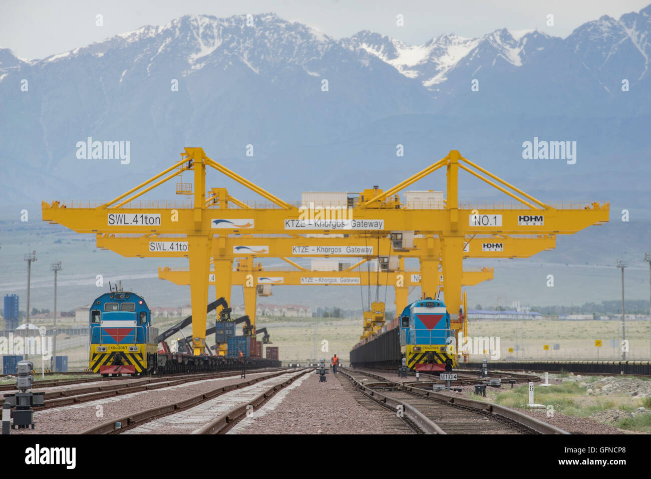 Trains with different gauges from China and Kazakhstan have loads transferred at a dry port in Khorgos, Kazakhstan. Stock Photo