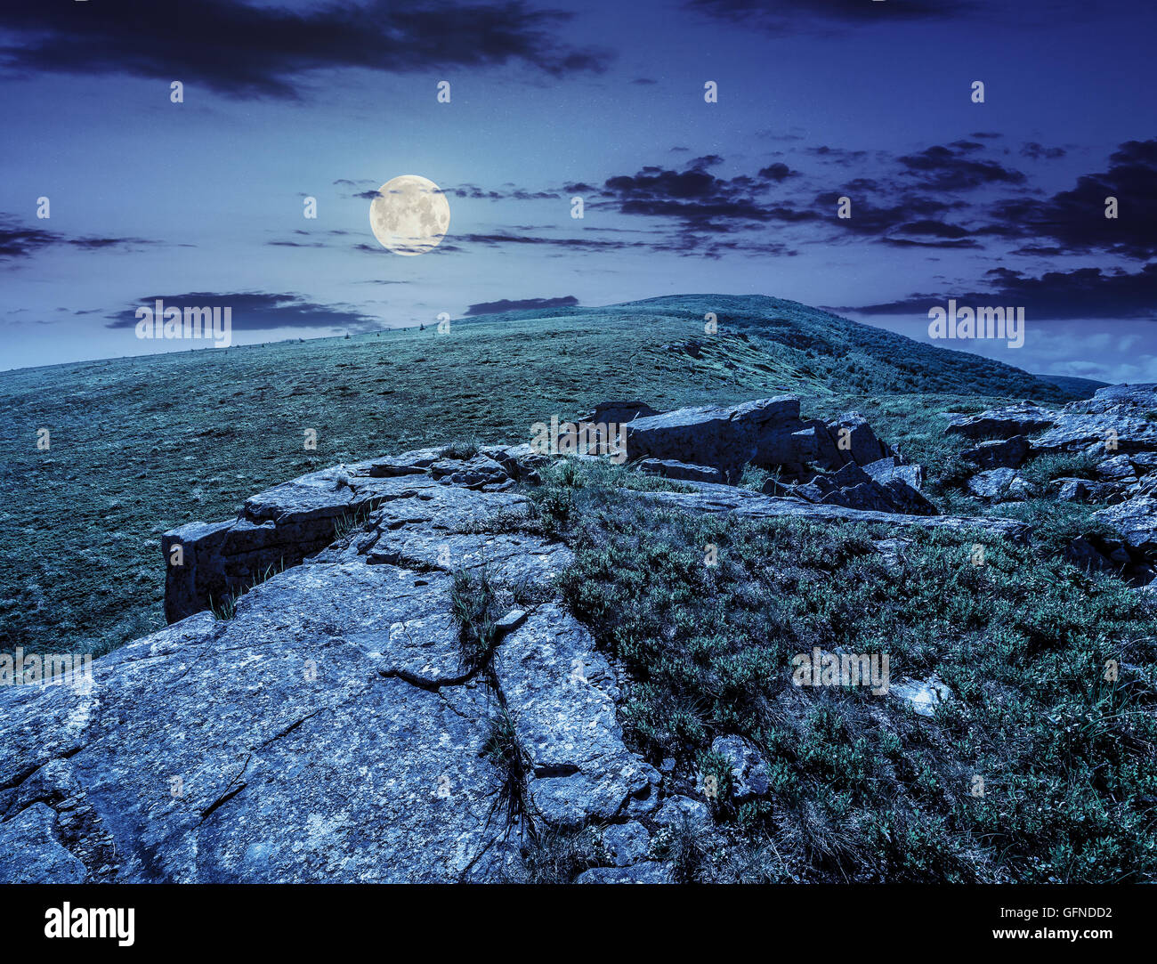 white sharp stones on the hillside on top of mountain range at night in ...
