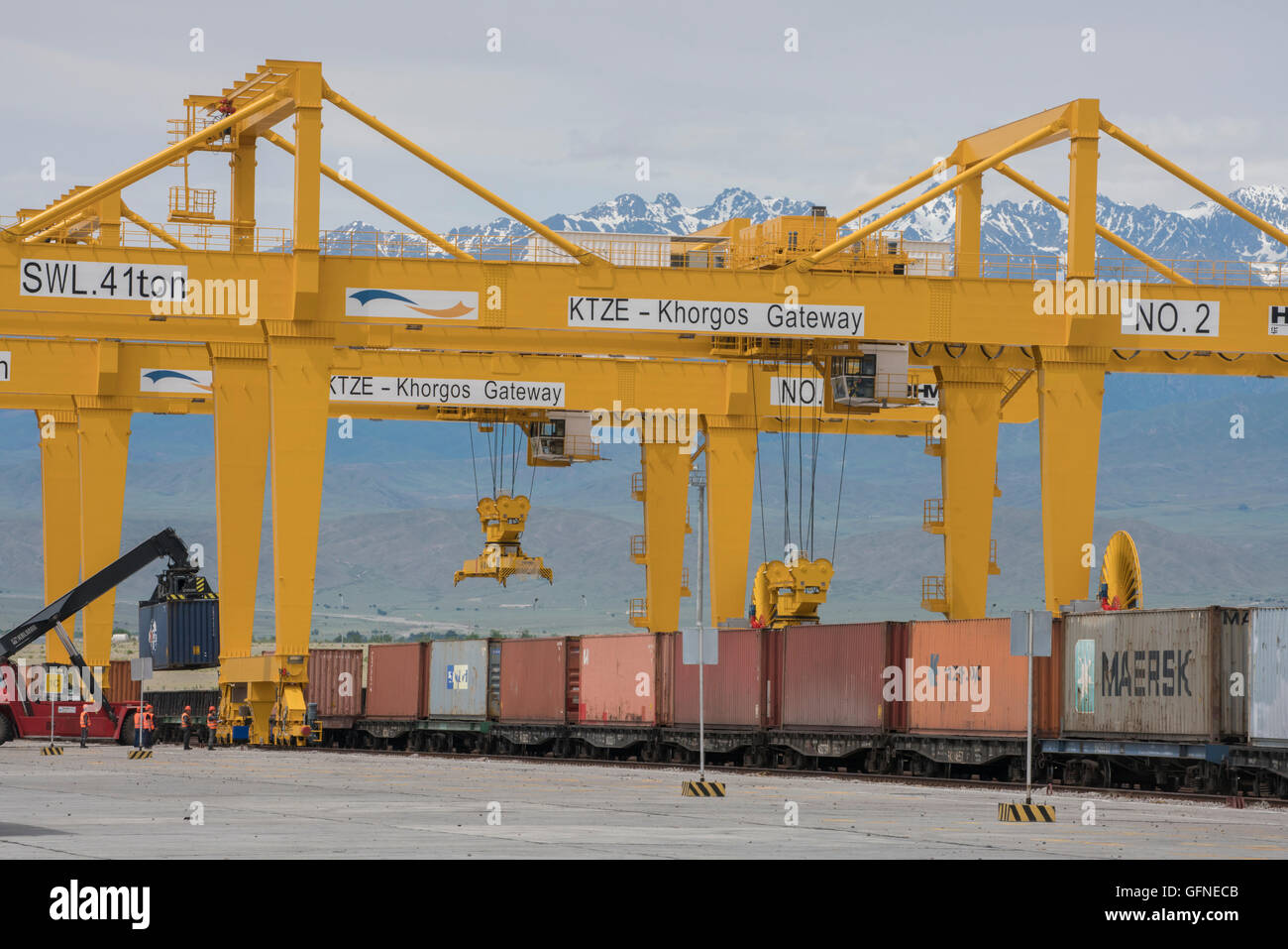 Trains with different gauges from China and Kazakhstan have loads transferred at a dry port in Khorgos, Kazakhstan. Stock Photo