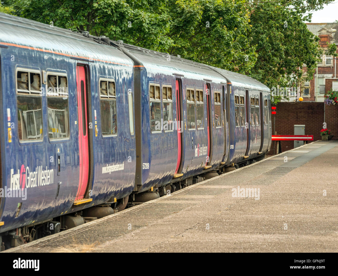 The Great Western Train formed of three carriages leaves Exmouth Station bound for Barnstaple along the picturesque Avocet line. Stock Photo