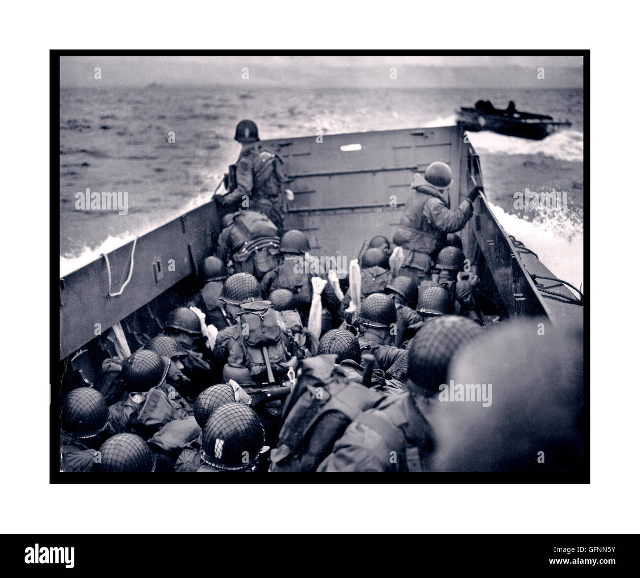 D-Day Omaha invasion beach landing craft under dark skies with American troops Normandy France 6th June 1944 Stock Photo