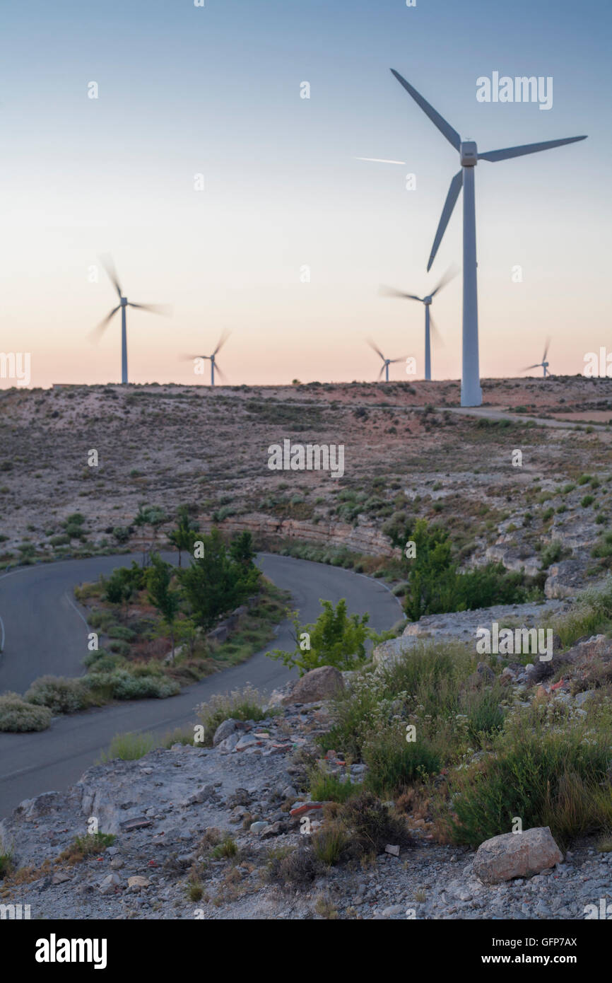 Electric wind turbines farm with on arid landscape with road, Spain Stock Photo