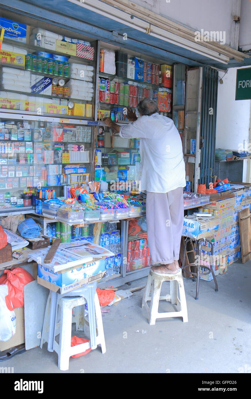 tobacco singapore A man works at a local tobacco shop in Singapore Stock Photo