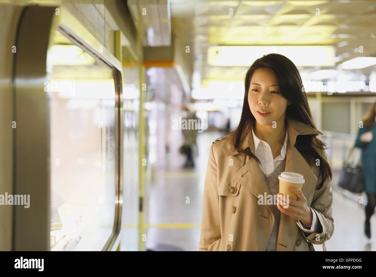 Young attractive Japanese woman at underground train station Stock Photo