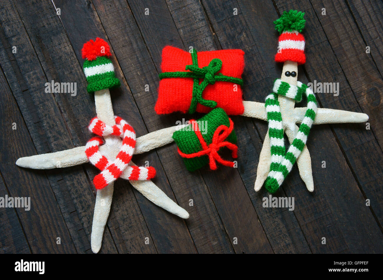 Christmas ornament for winter holiday, red and green knitted hat, scaft, sock, gift  in small size, symbol for xmas, noel season Stock Photo