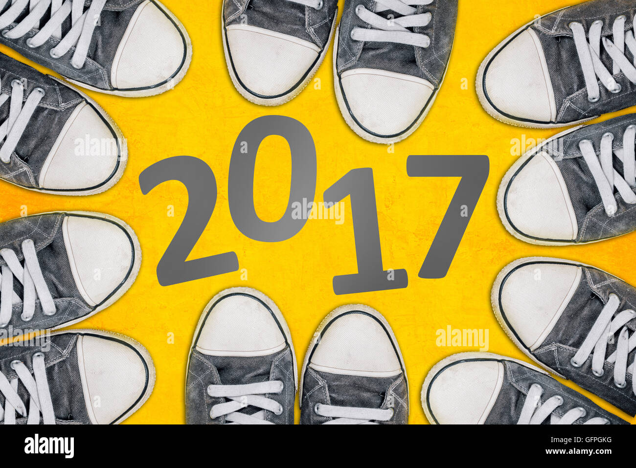 Happy new year concept, young people wearing sneakers from above surrounding number 2017 Stock Photo