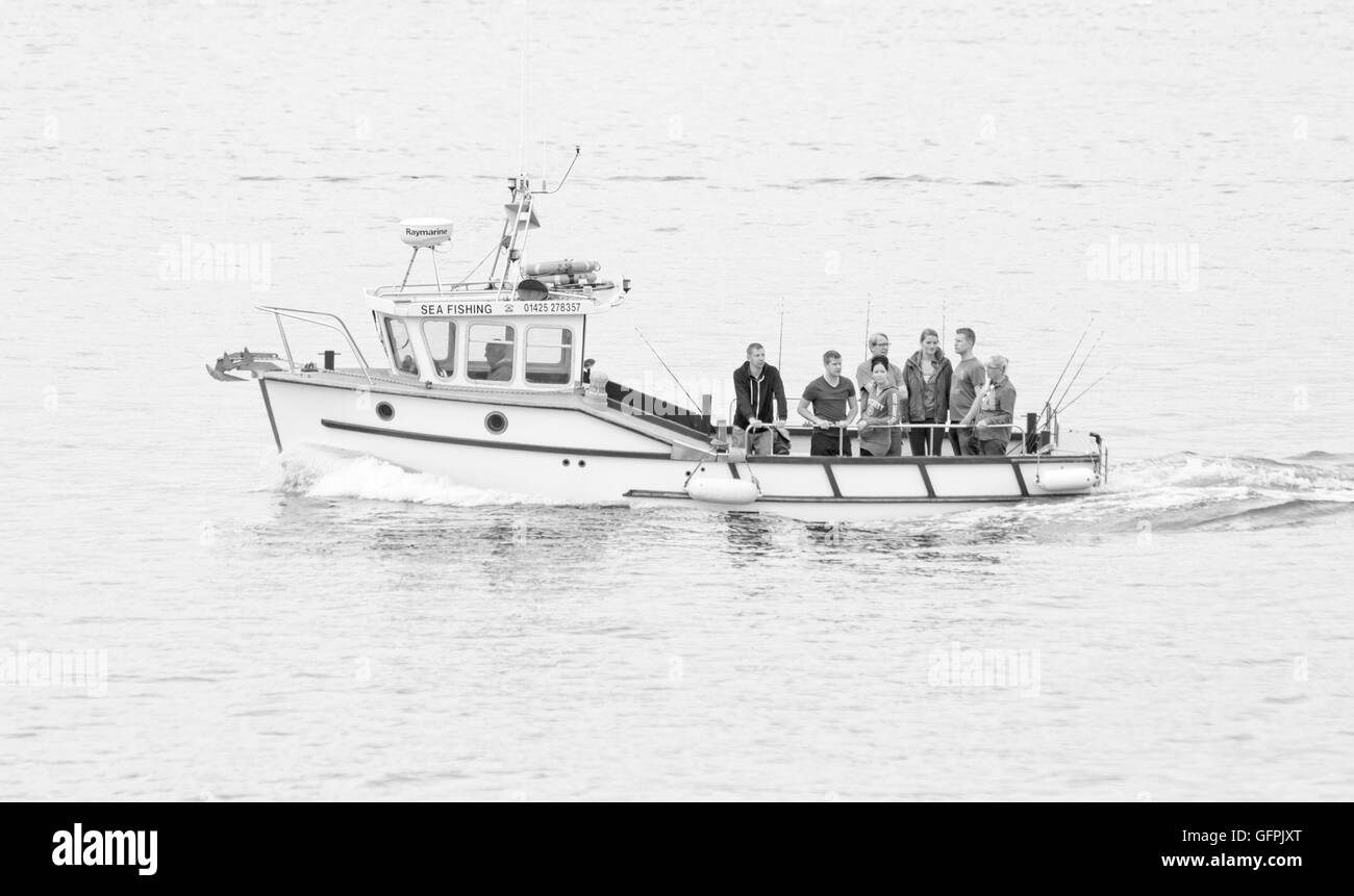 Group going out for sea fishing trip at Poole Harbour in July Stock Photo