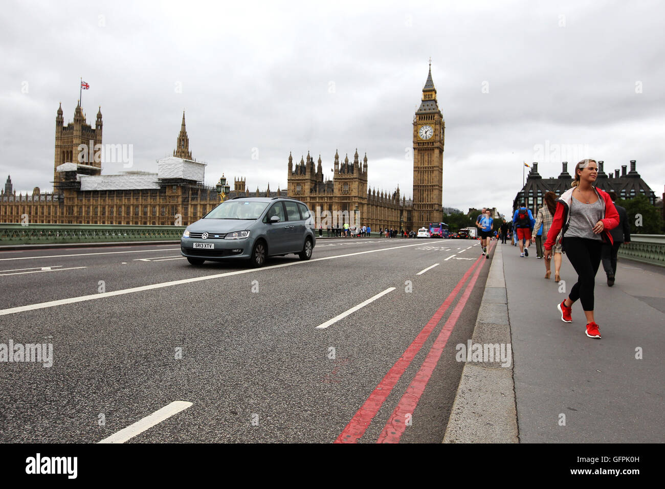 A unmarked emergency vehicle travels over Westminster bridge with the house of Parliament and Big Ben (Elizabeth Tower) in view Stock Photo
