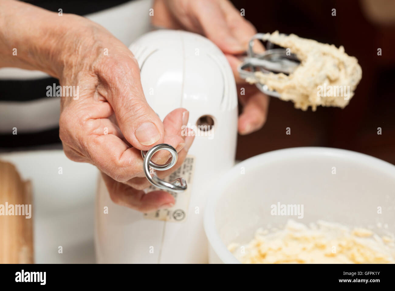 Taking away beaters and putting on hooks for mixing dough Stock Photo