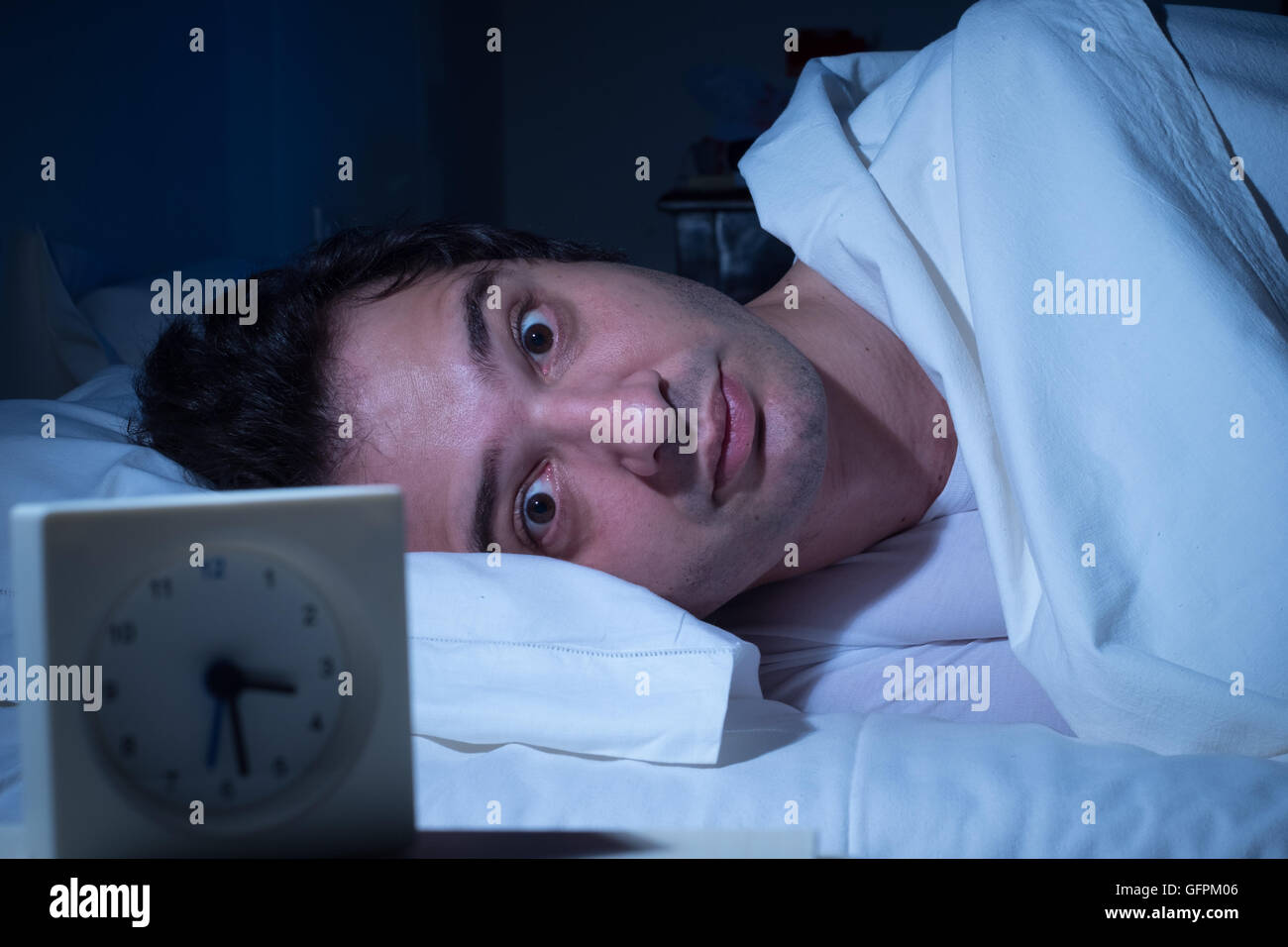Stressed man suffering for insomnia can't sleep in his bed Stock Photo