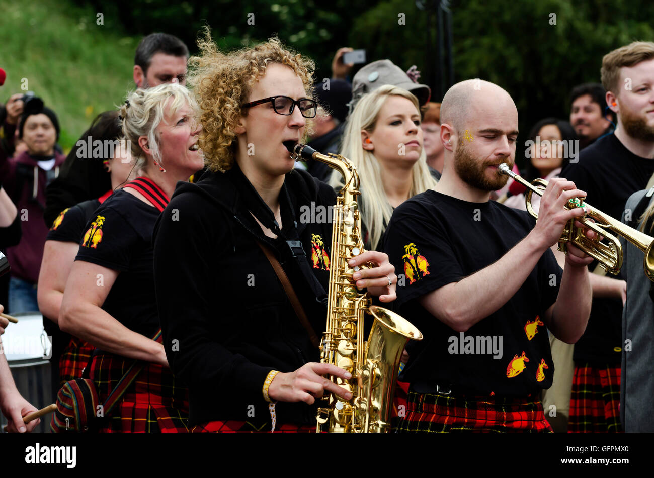 Female sax player and trumpeter with a band taking part in the Carnival