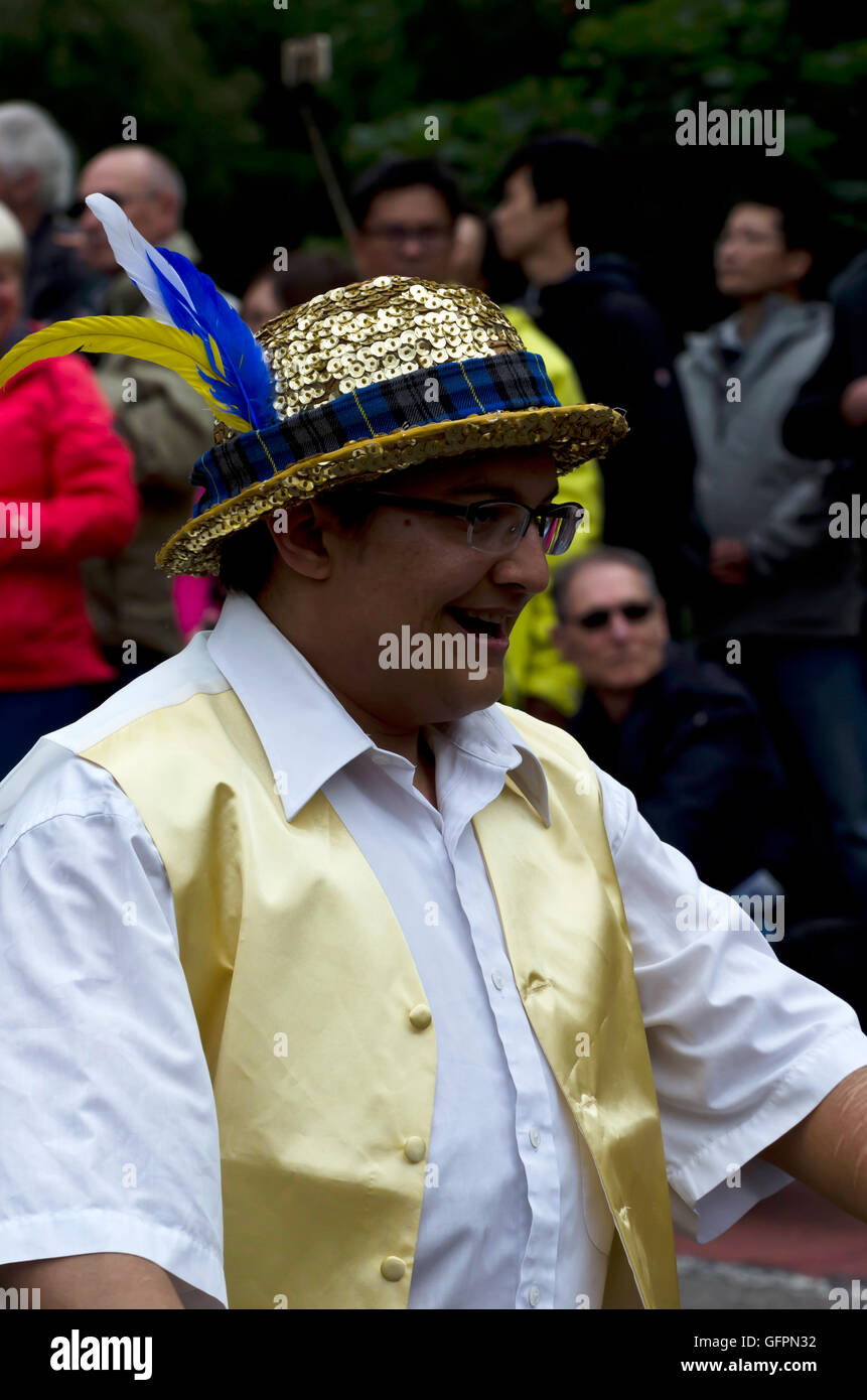 Man in a gold sequinned bowler hat taking part in the Carnival Parade, part of the Edinburgh Jazz Festival. Stock Photo