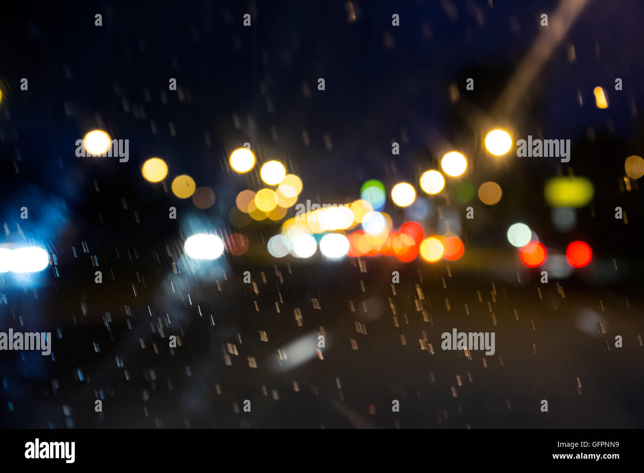 looking on blurry glowing cars lights through windscreen Stock Photo