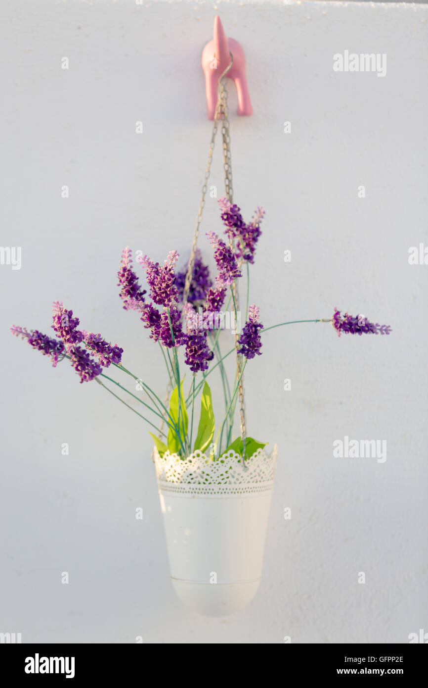Artificial flowers on wall Stock Photo
