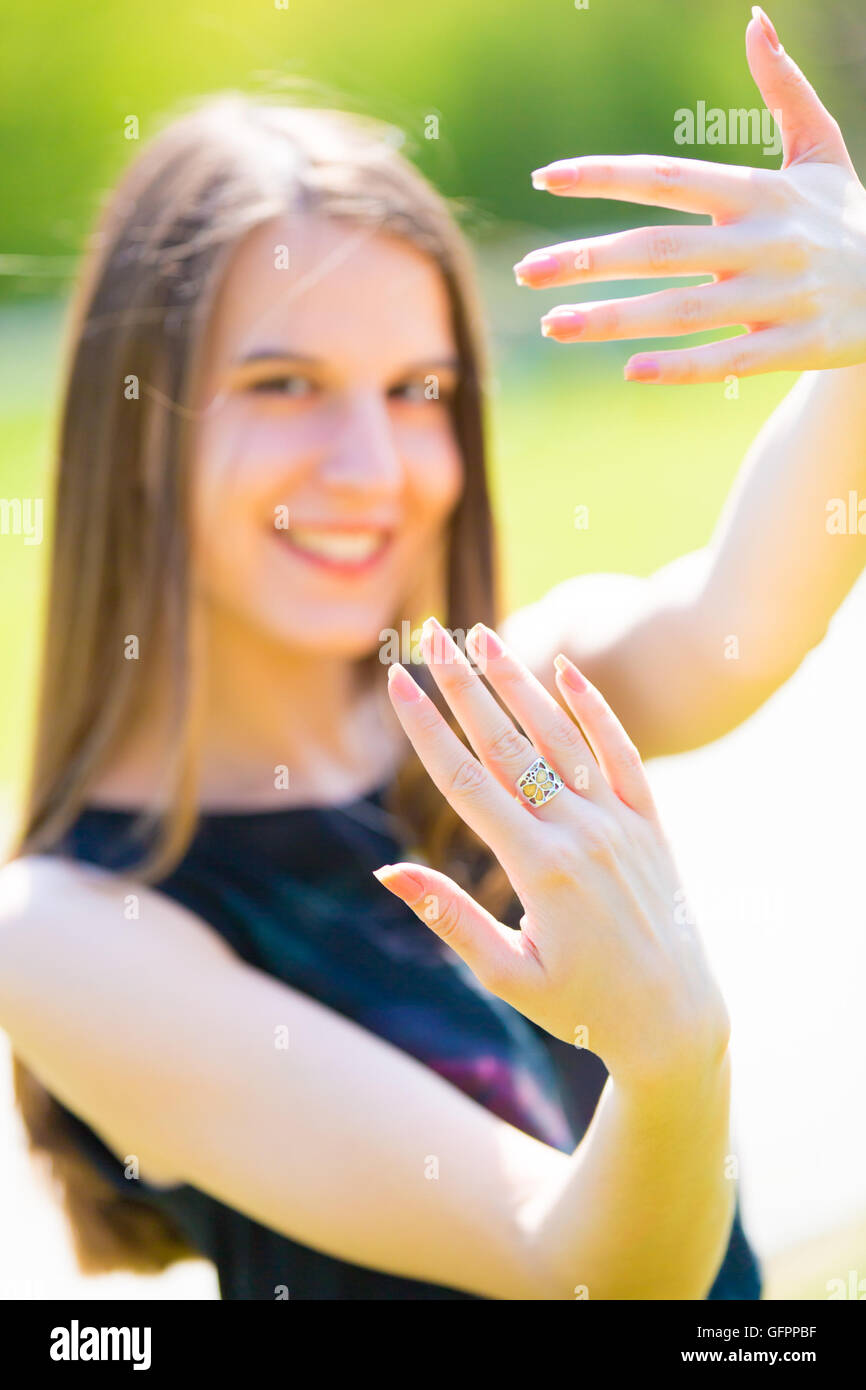 A girl shows nails outdoor in summer park Stock Photo