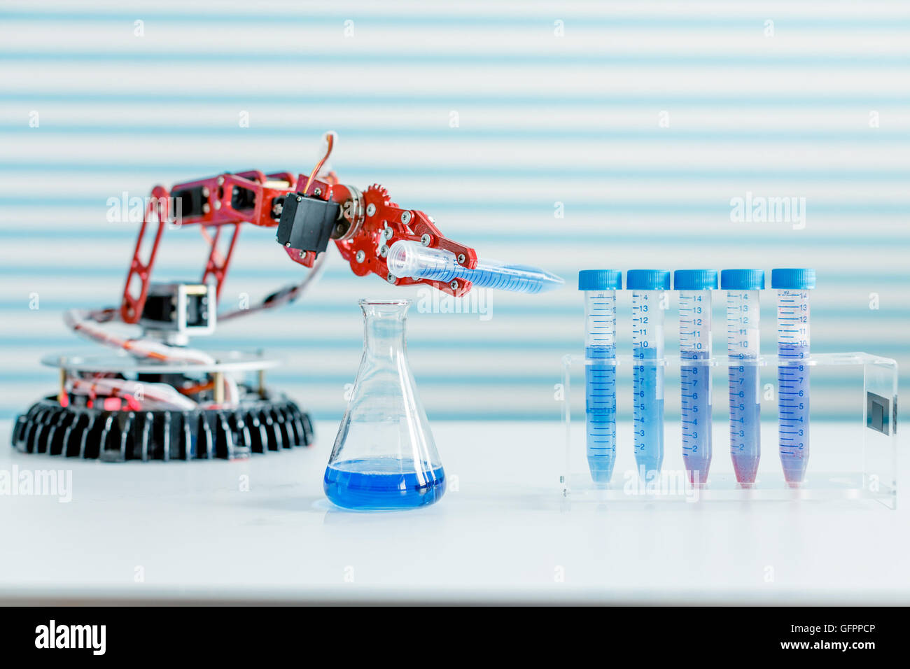 robot manipulates test tubes with dangerous chemicals Stock Photo