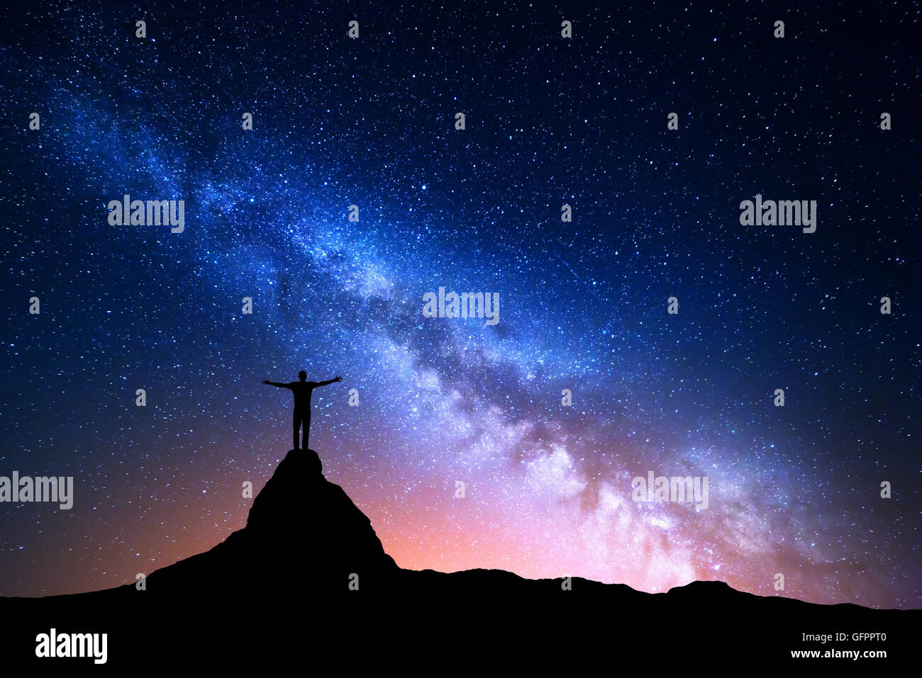 Night landscape with Milky Way. Silhouette of a standing man with ...