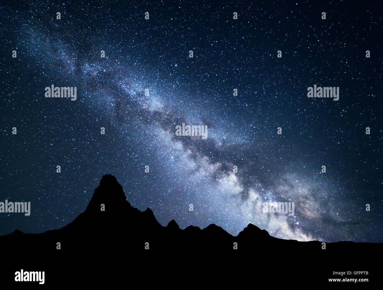 Night landscape with amazing Milky Way and mountain peak. Starry sky with high rocks at summer. Beautiful Galaxy. Universe. Spac Stock Photo