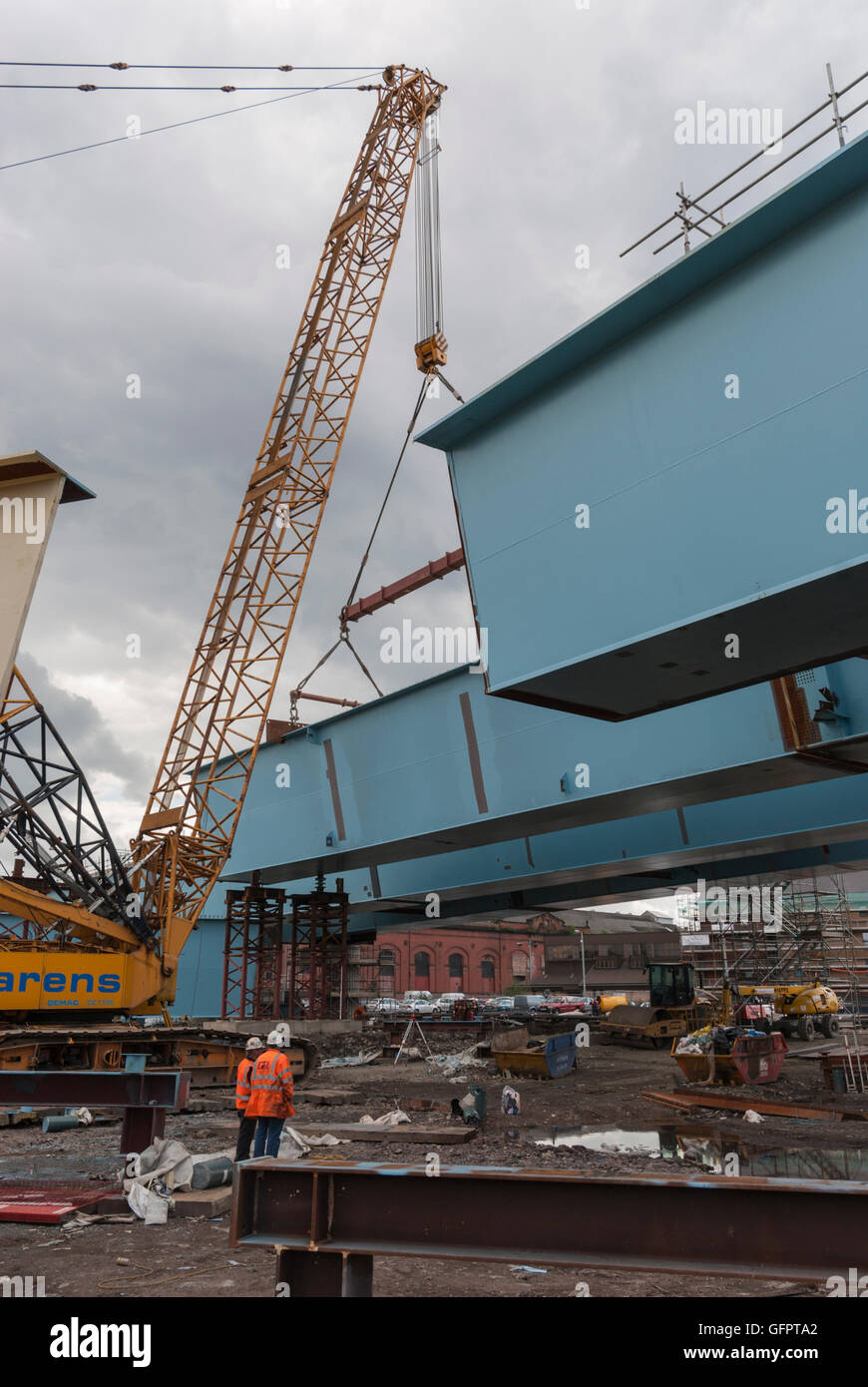Box girder section suspended by crane, M74 extension bridge