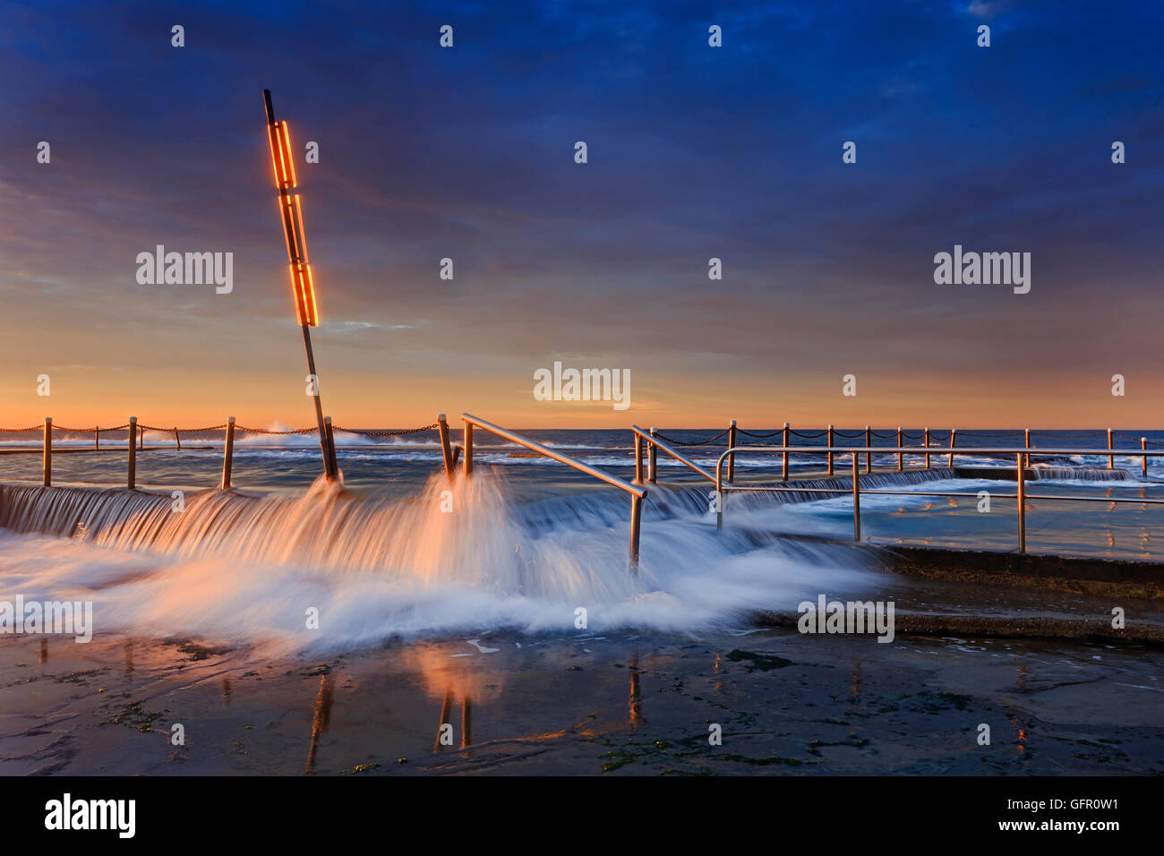 mona vale rock pool entrance steps and wire fence under overflowing