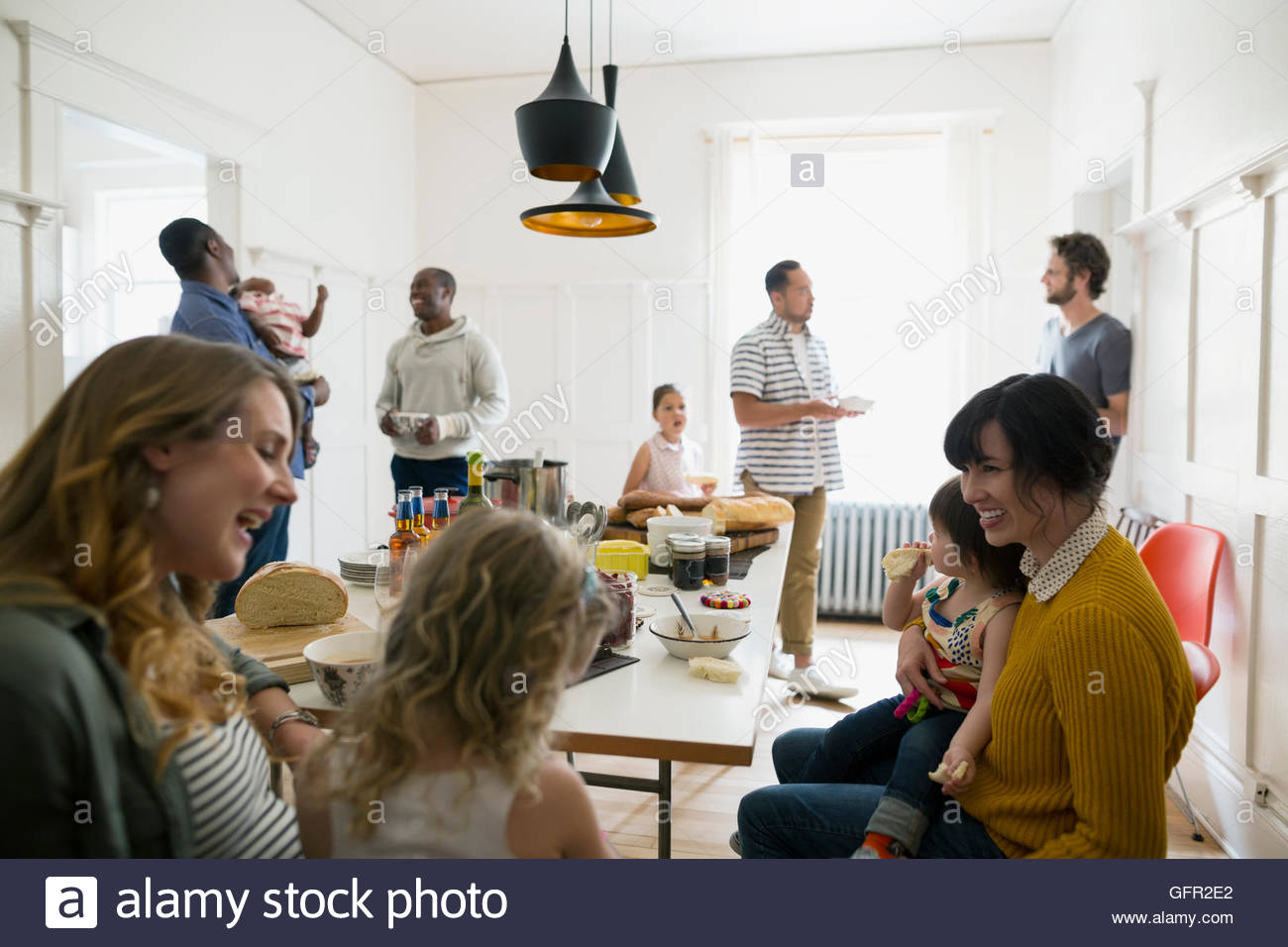 Families talking enjoying lunch buffet in dining room Stock Photo Alamy