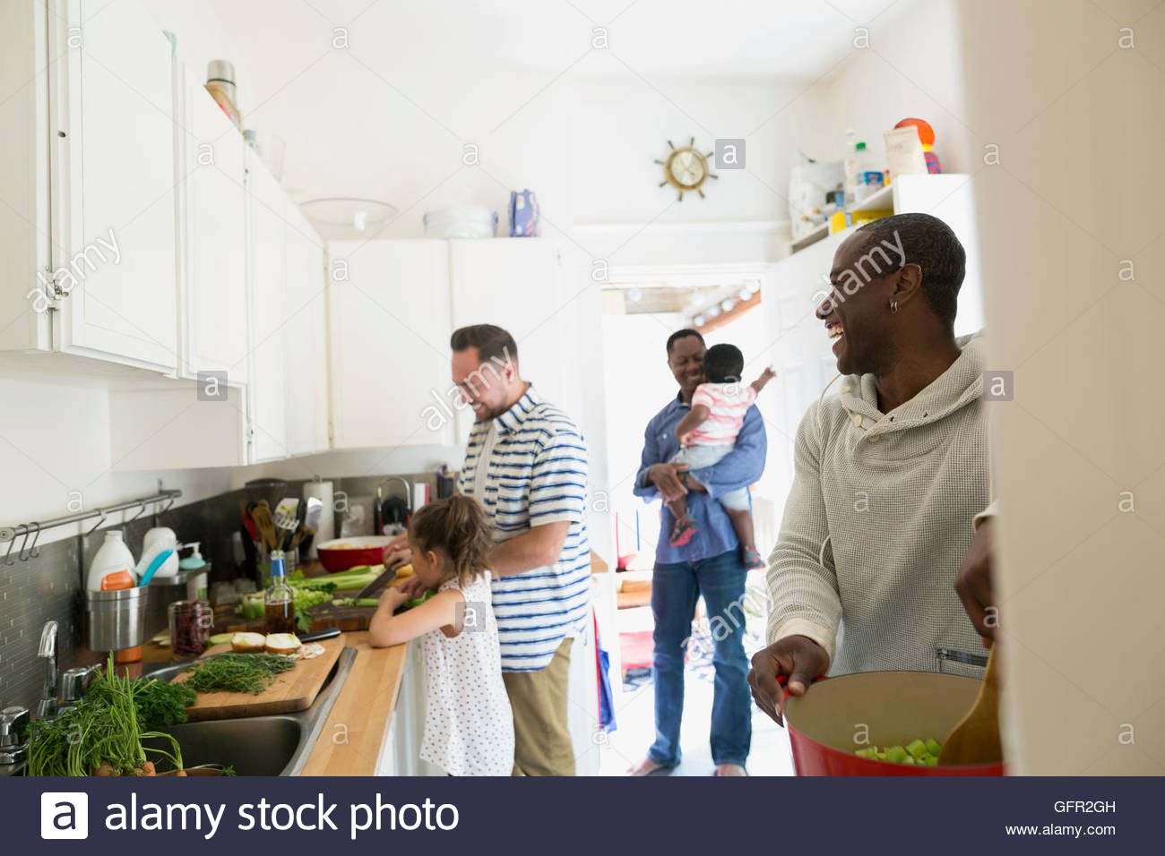 Fathers and children cooking in kitchen Stock Photo