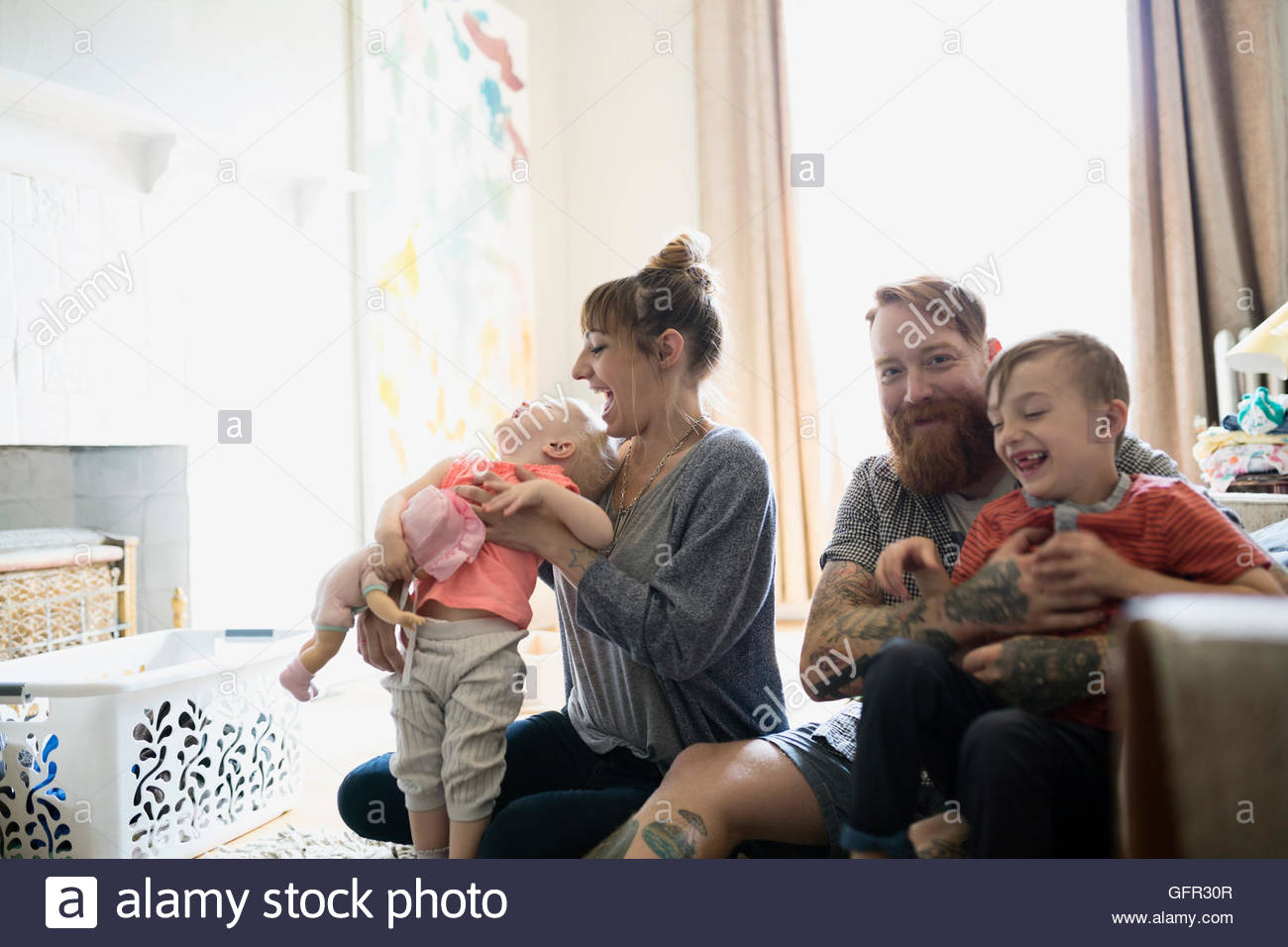 Happy young family in living room Stock Photo