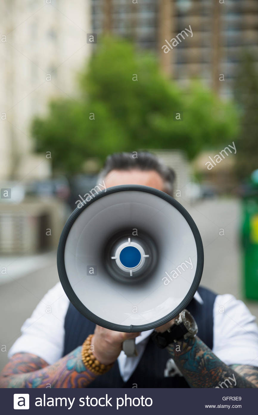Hipster with tattoos using megaphone Stock Photo Alamy