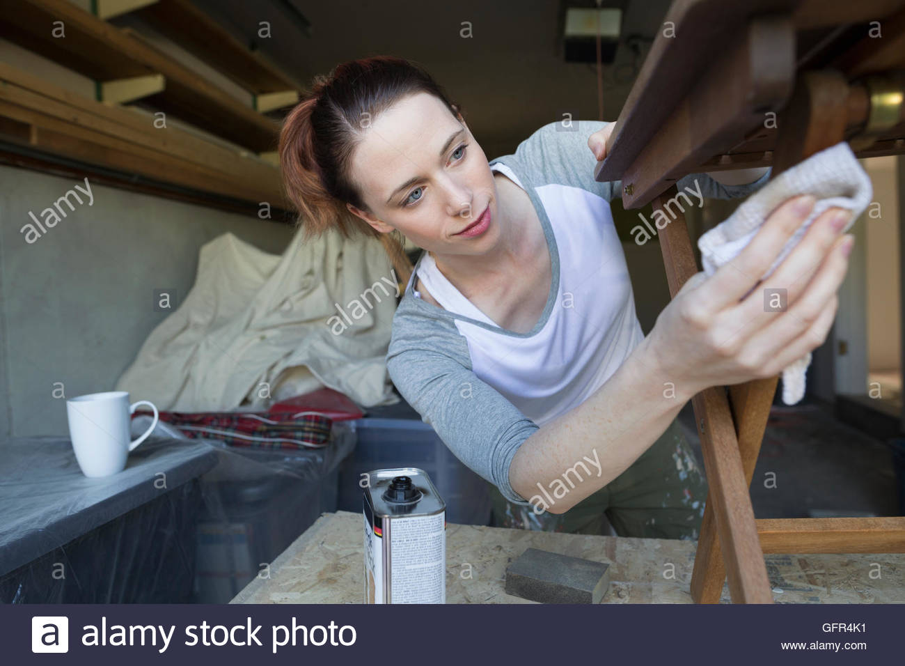 Woman staining wood furniture home improvement project Stock Photo Alamy