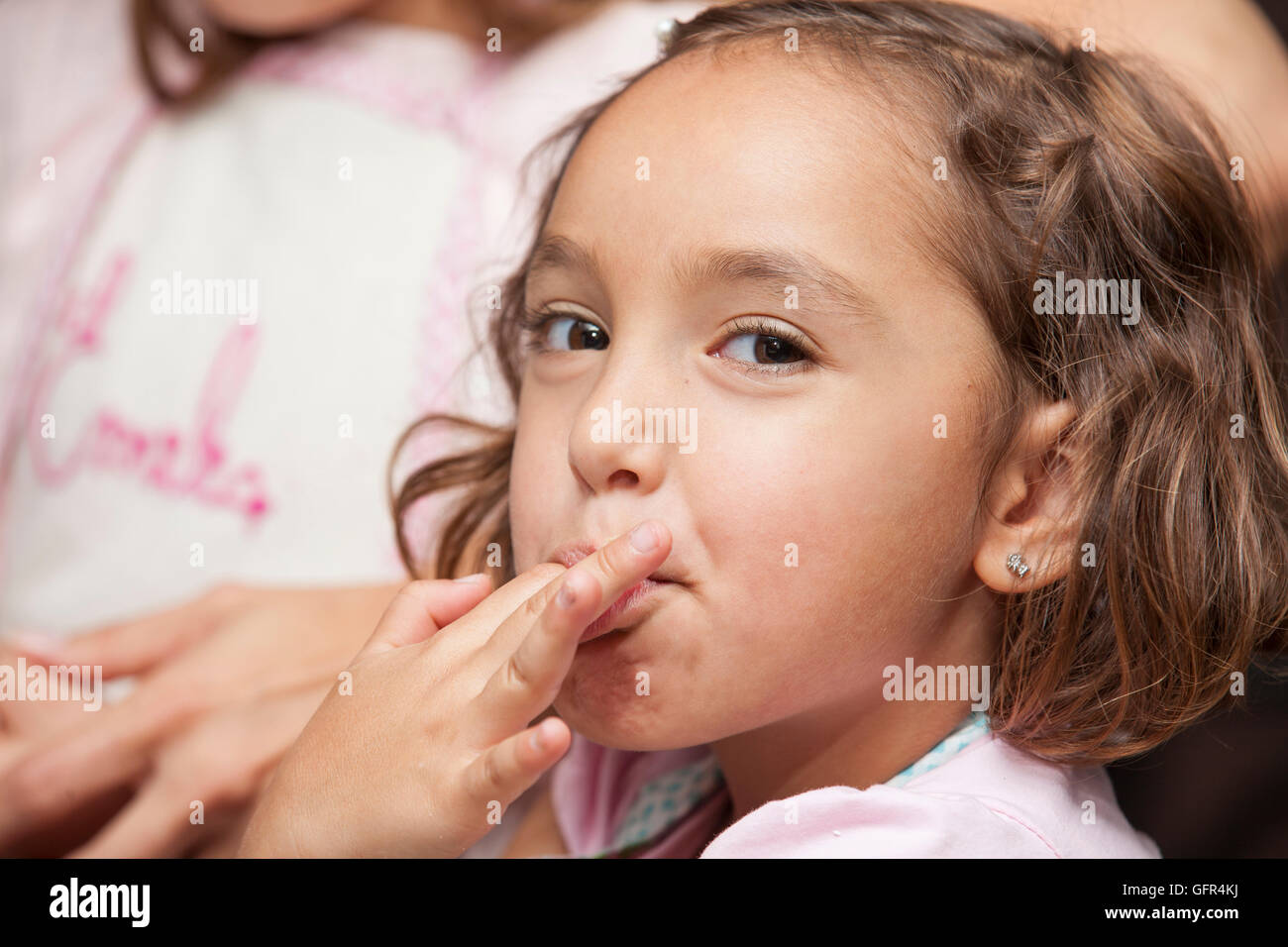 Little girl tasting the cupcakes dough Stock Photo Alamy