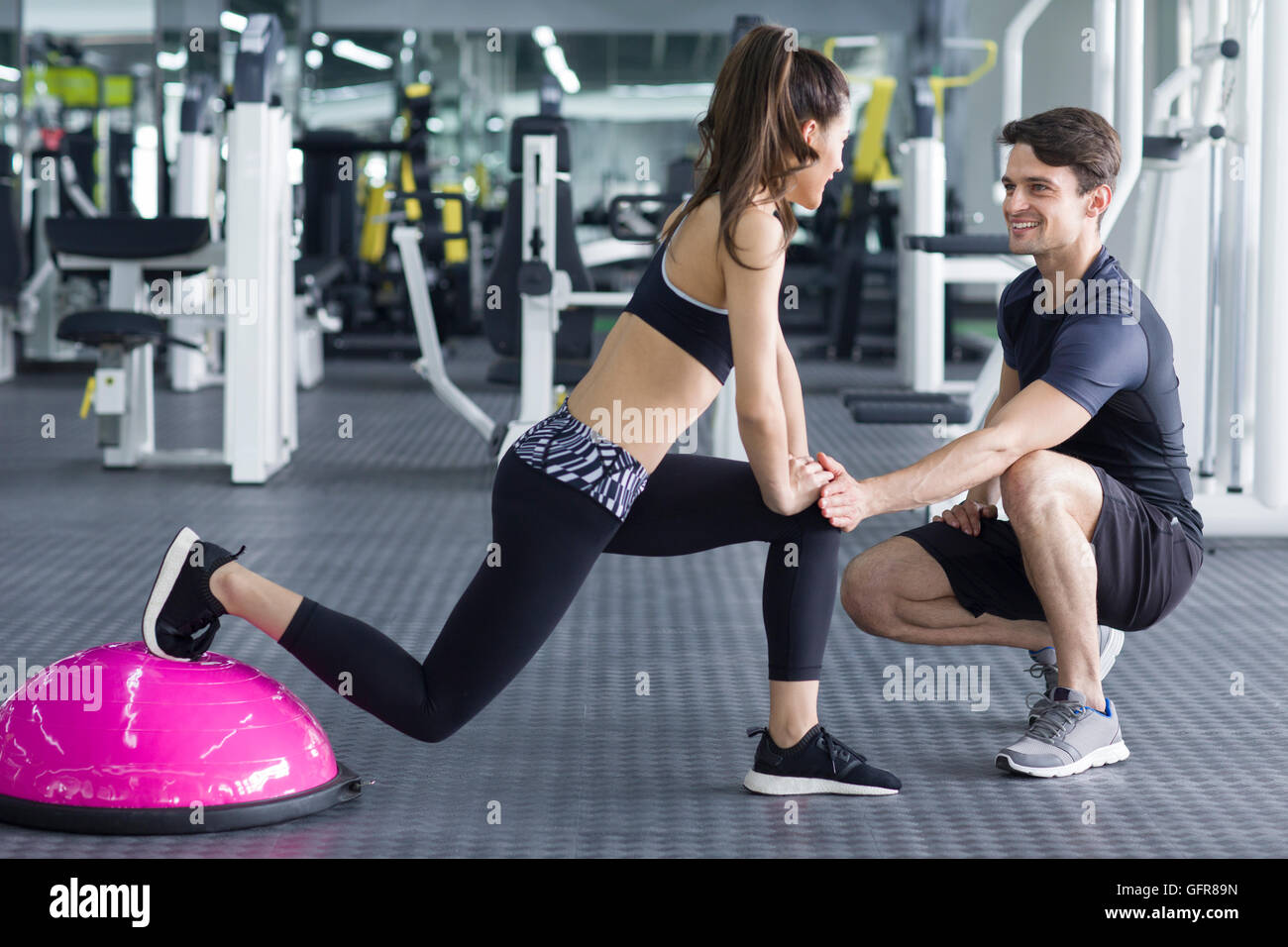 Young Chinese woman working with trainer at gym Stock Photo - Alamy