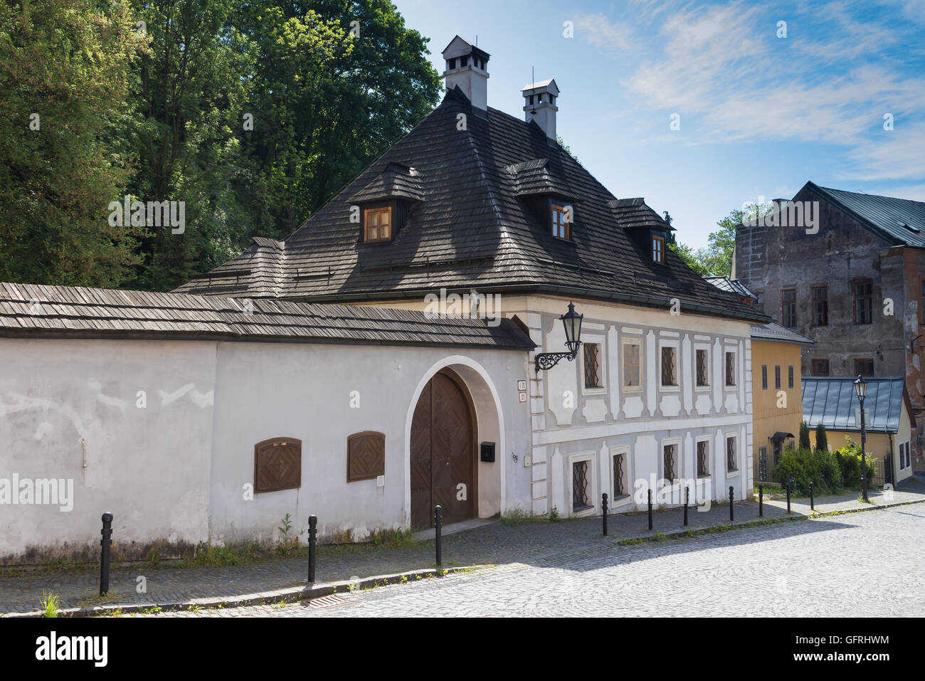 Street in Banska Stiavnica, former mining city, which is in the UNESCO World Heritage list. Calm summer morning. Stock Photo