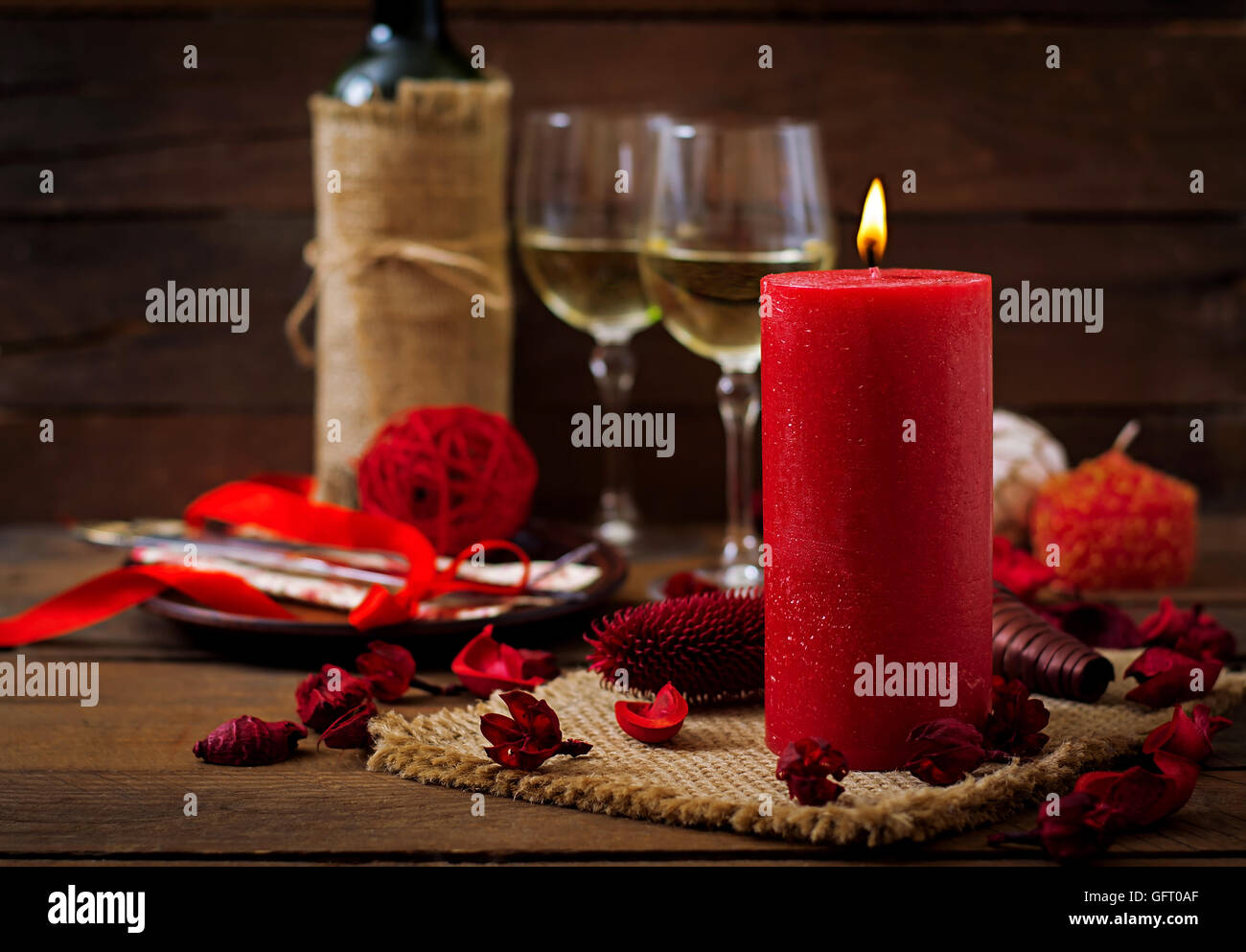Romantic dinner setting, candles, wine and decor Stock Photo - Alamy