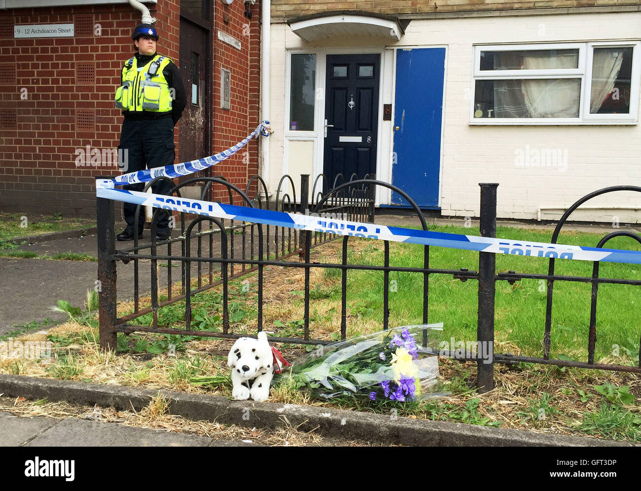 A police officer stands outside a property in Archdeacon Street, Gloucester, where a baby boy was seriously injured in an incident and has died. Stock Photo