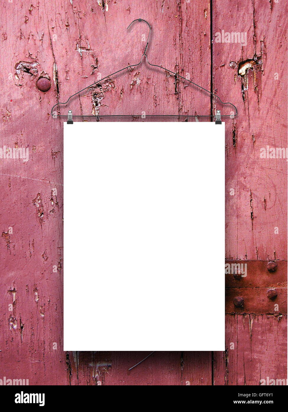 Close-up of one blank frame hanged by clothes hanger against pink weathered wooden background Stock Photo