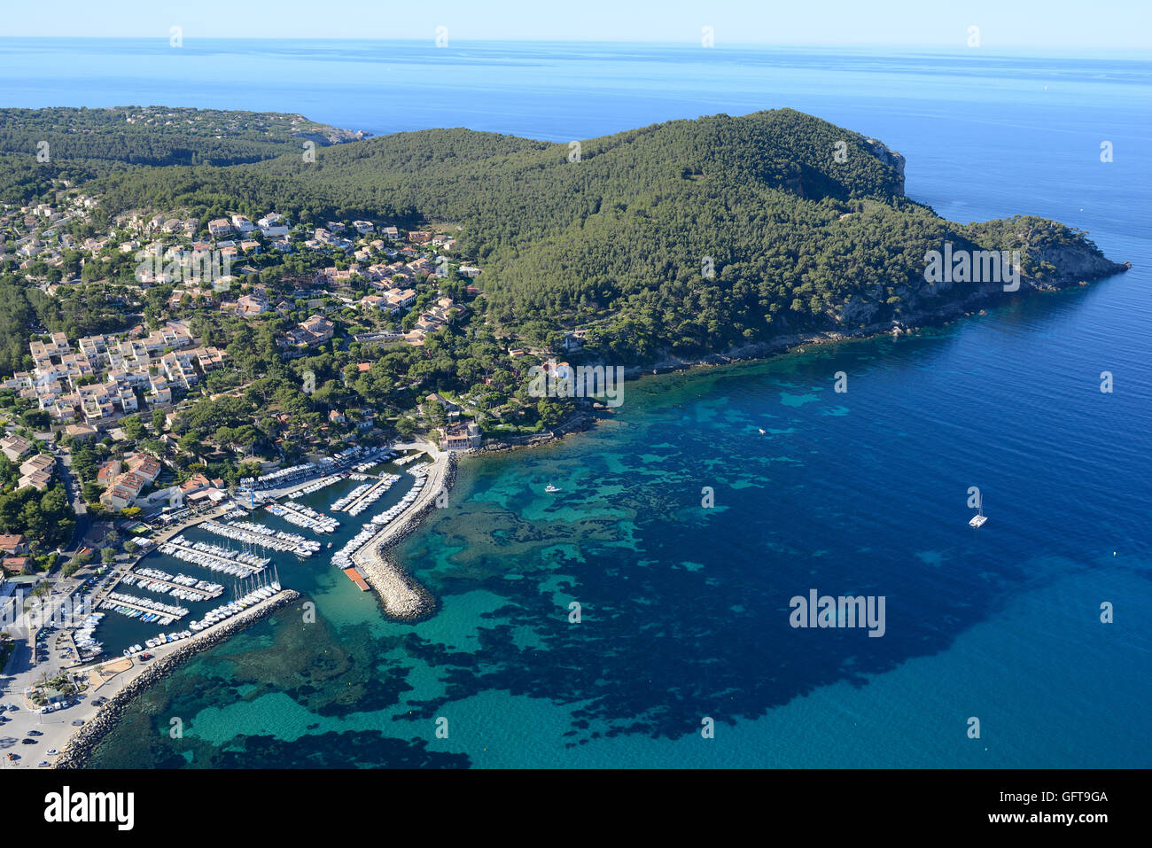 AERIAL VIEW. The small Marina of La Madrague with the picturesque seaside forest of Bay des Lecques. Saint-Cyr-sur-Mer, Var, Provence, France. Stock Photo