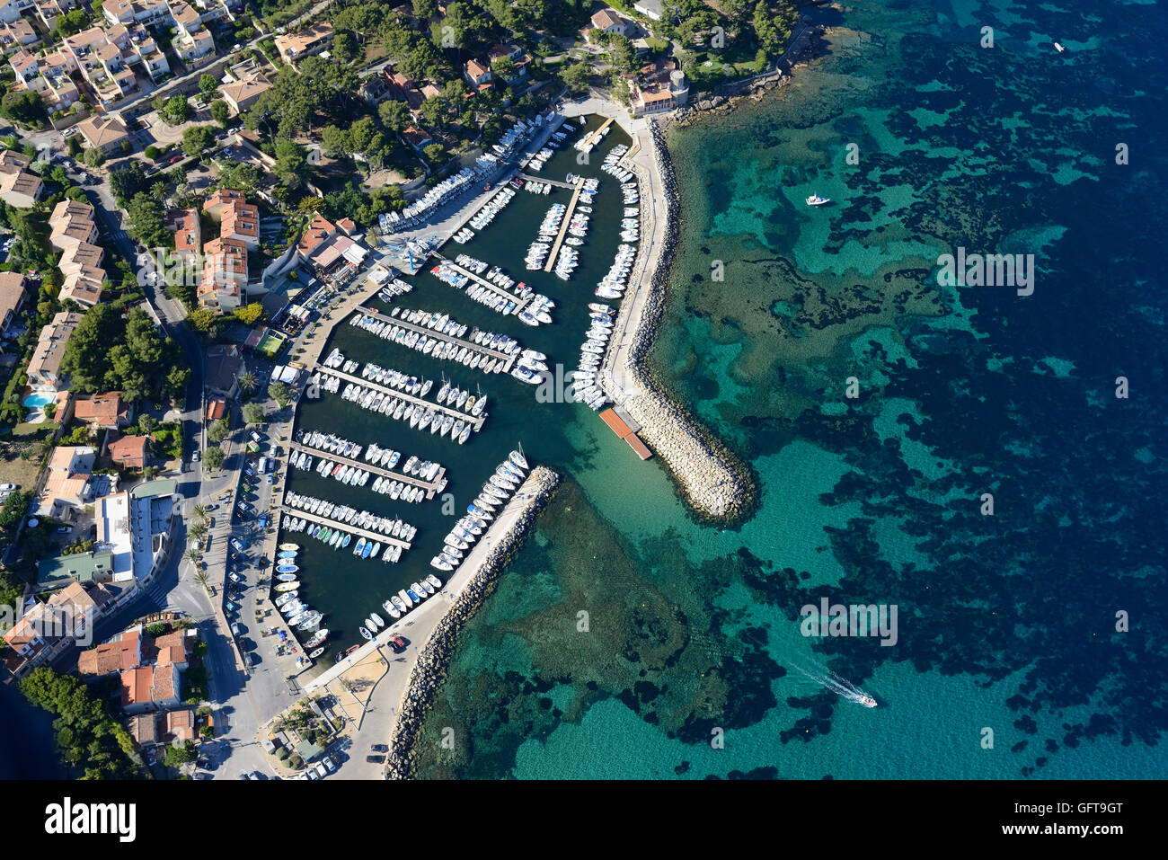 AERIAL VIEW. The small Marina of La Madrague with the colorful seafloor of Bay des Lecques. Saint-Cyr-sur-Mer, Var, Provence, France. Stock Photo