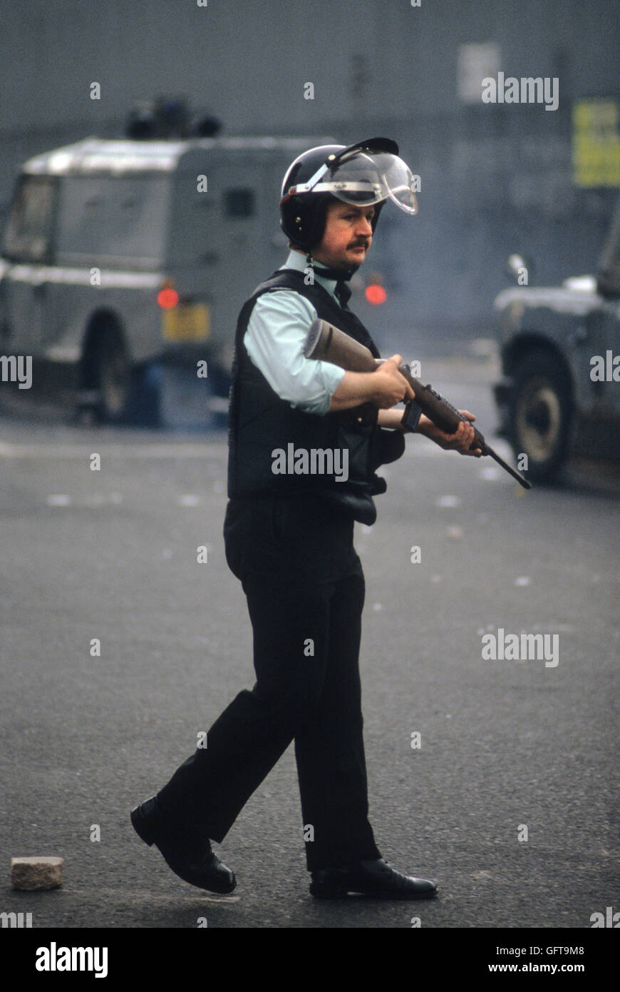 RUC officer armed patrolling street of Belfast during riots immediately afterwards Bobby Sands funeral. 1981 The Troubles 1980s HOMER SYKES. Stock Photo