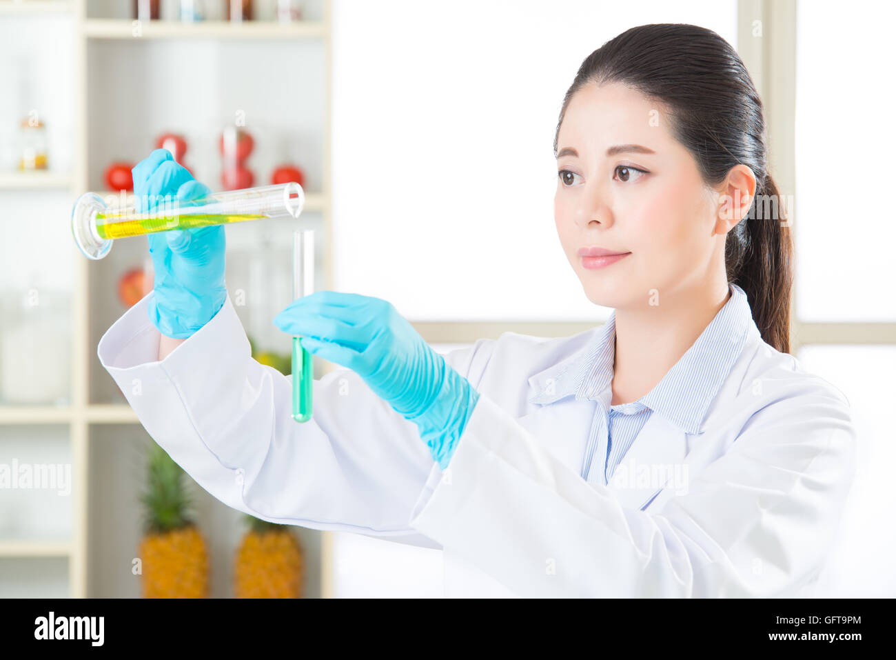 chemistry researchers observing indicator color shift of gmo food Stock Photo