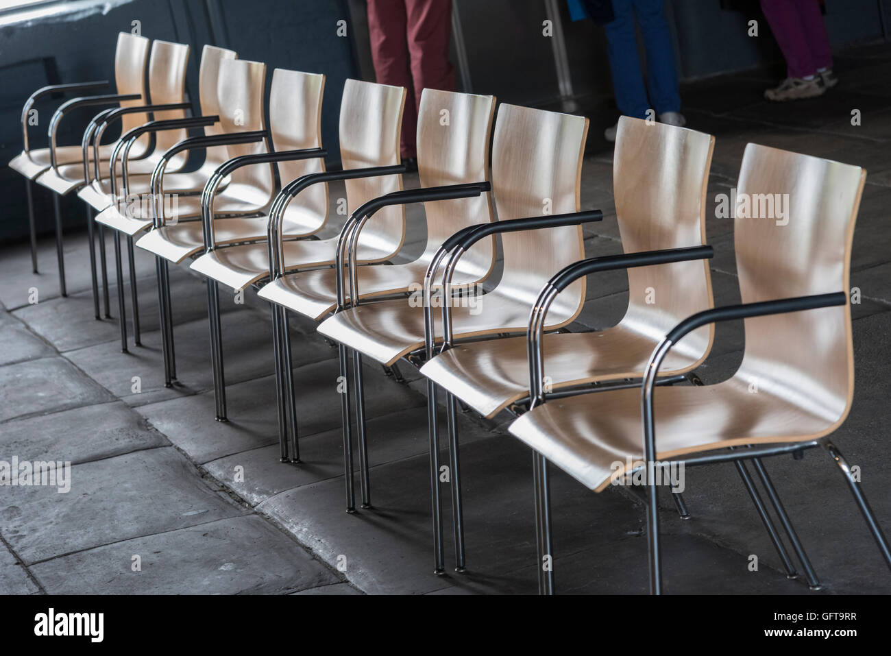 A row of chairs. wood and steel chromed Stock Photo