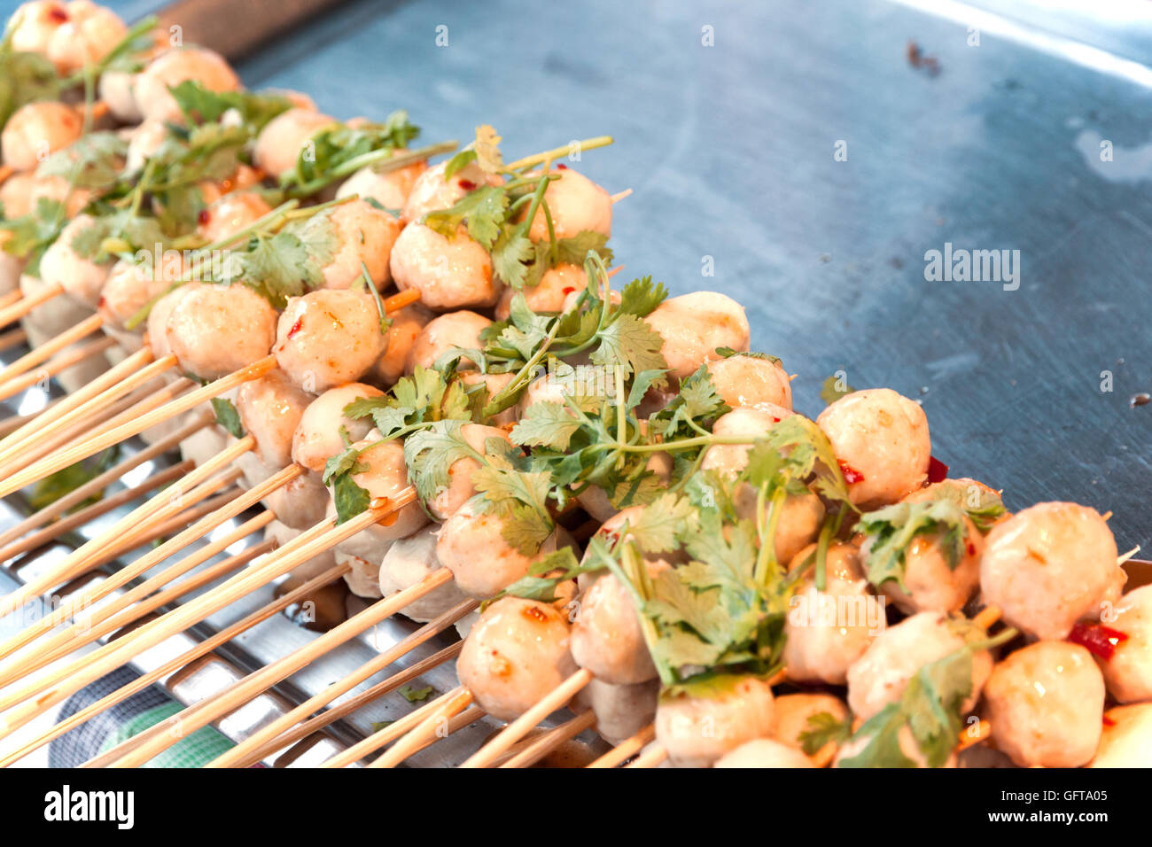 pork meat ball grill. Thai snack on stainless tray sale at food street Stock Photo