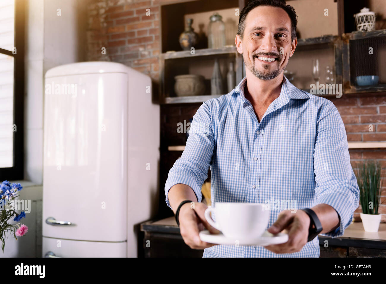 Man giving you a cup of coffee Stock Photo