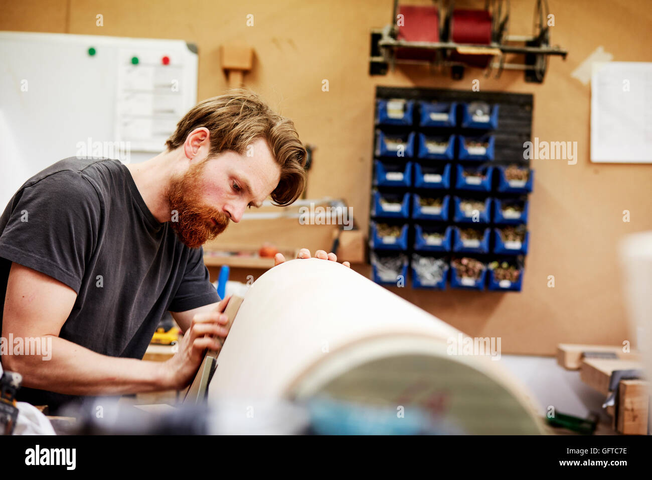 Furniture A man working on a curved wooden piece Stock Photo Alamy