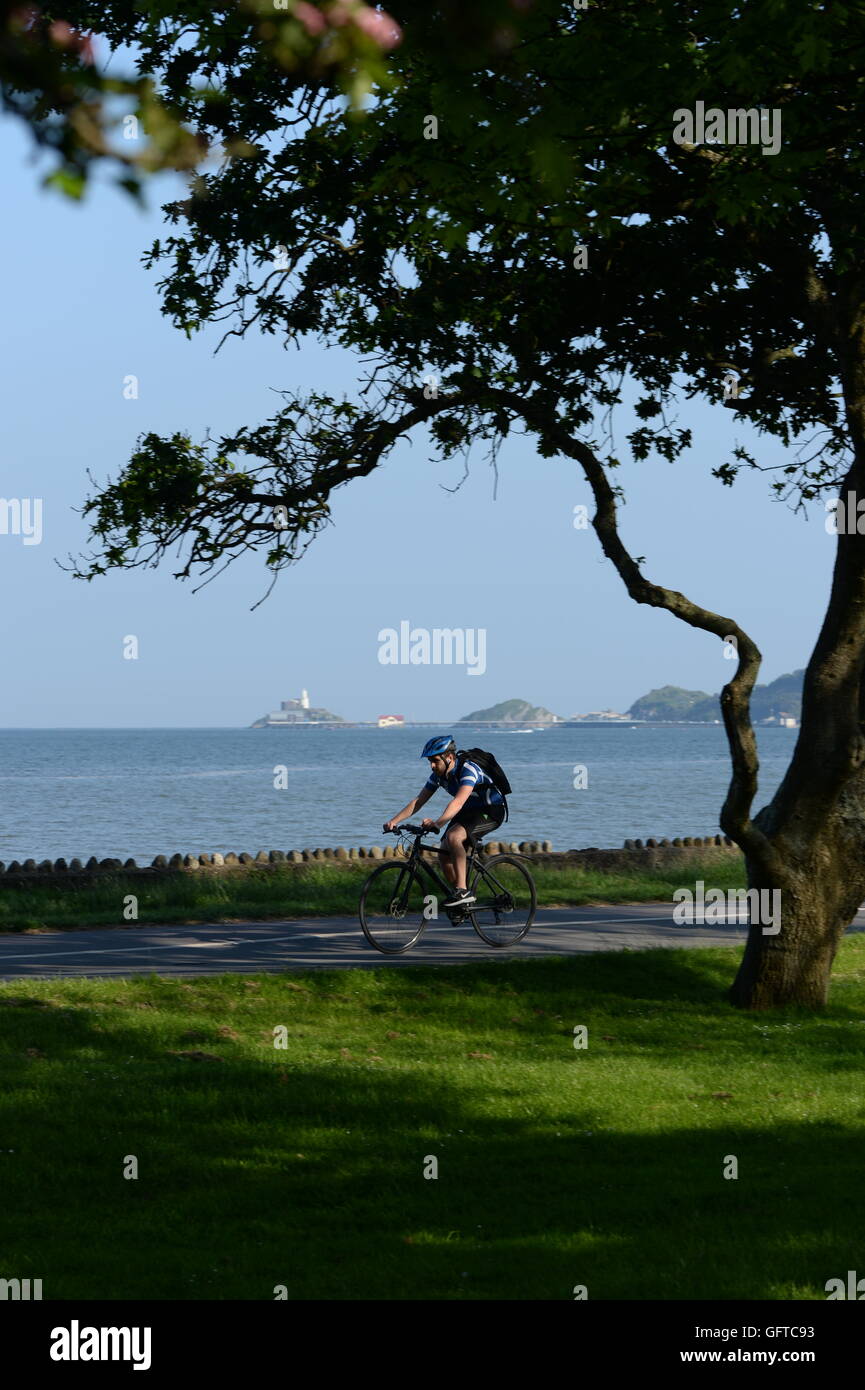 cyclist on Swansea Bay cycle path, Mumbles background. Mumbles was voted best place to live in Wales 2018. Stock Photo