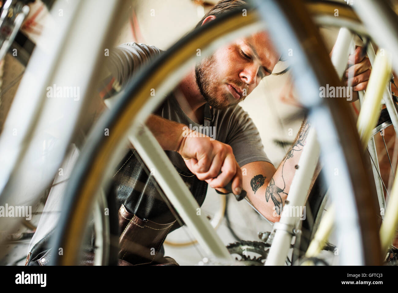 A man working in a bicycle repair shop Stock Photo Alamy