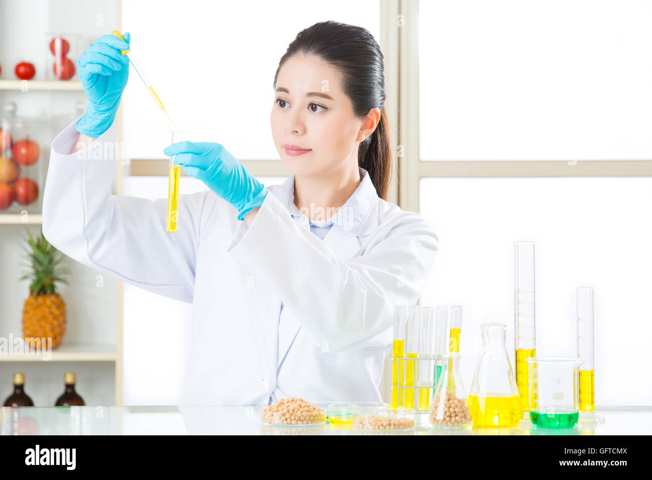chemistry researchers observing indicator color shift of gmo food Stock Photo