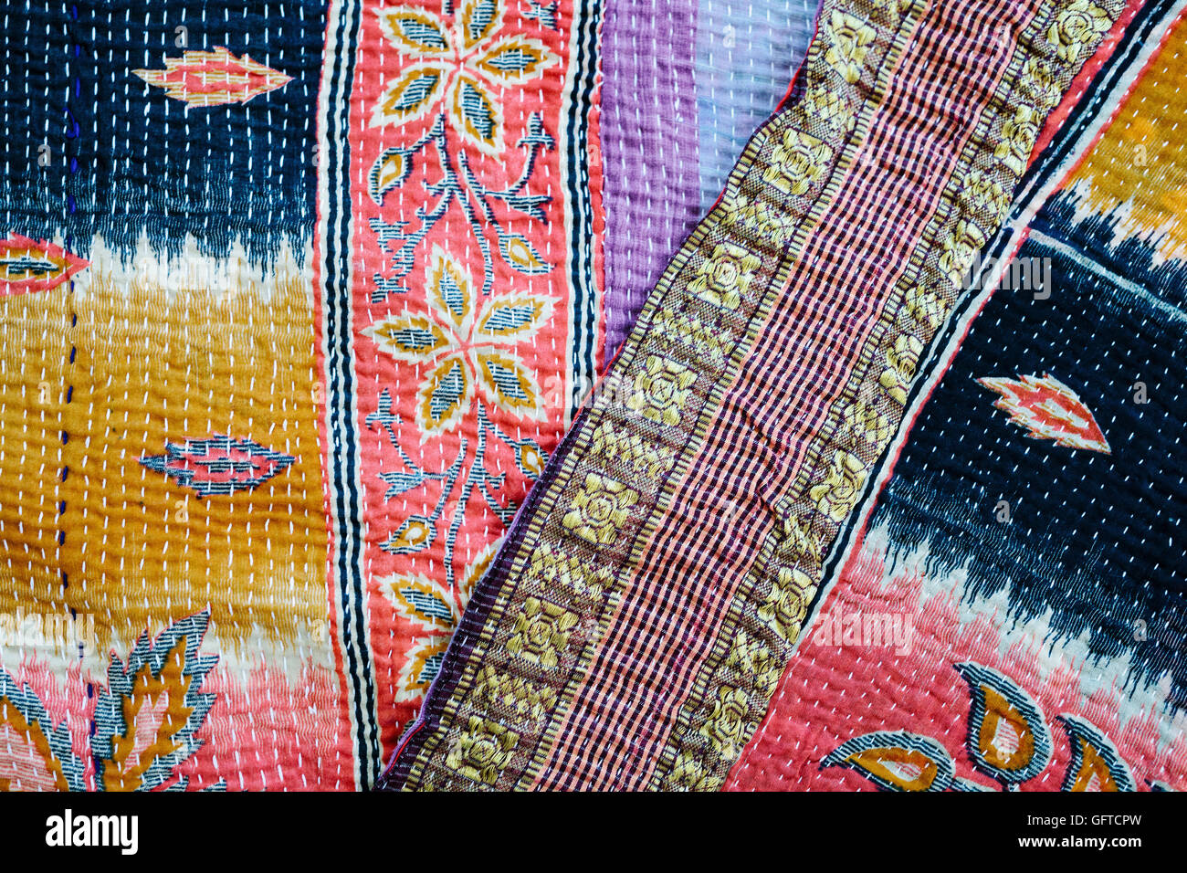 Close up of a fabric bedspread or throw with different fabrics