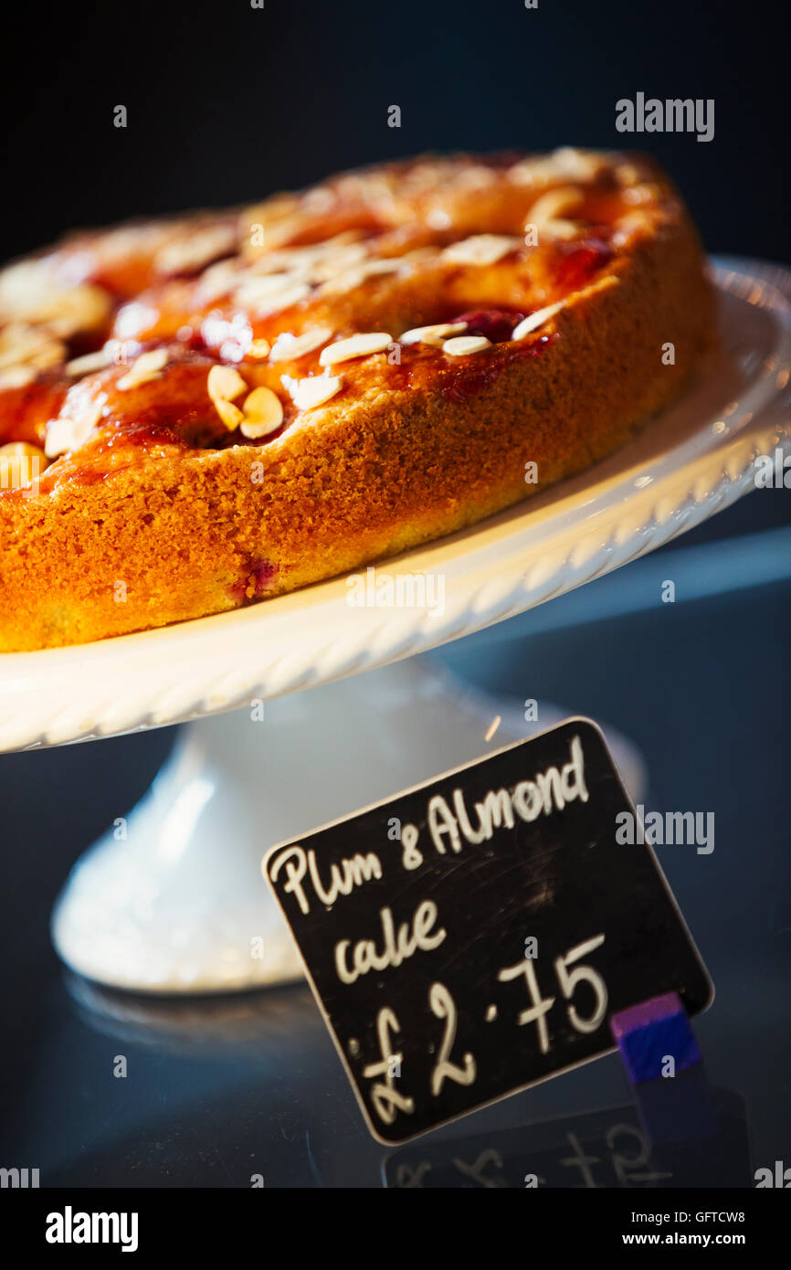 Plum and almond cake on a cake stand Stock Photo
